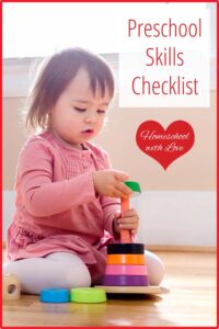 Little girl playing with stacking circles. Preschool Skills Checklist.